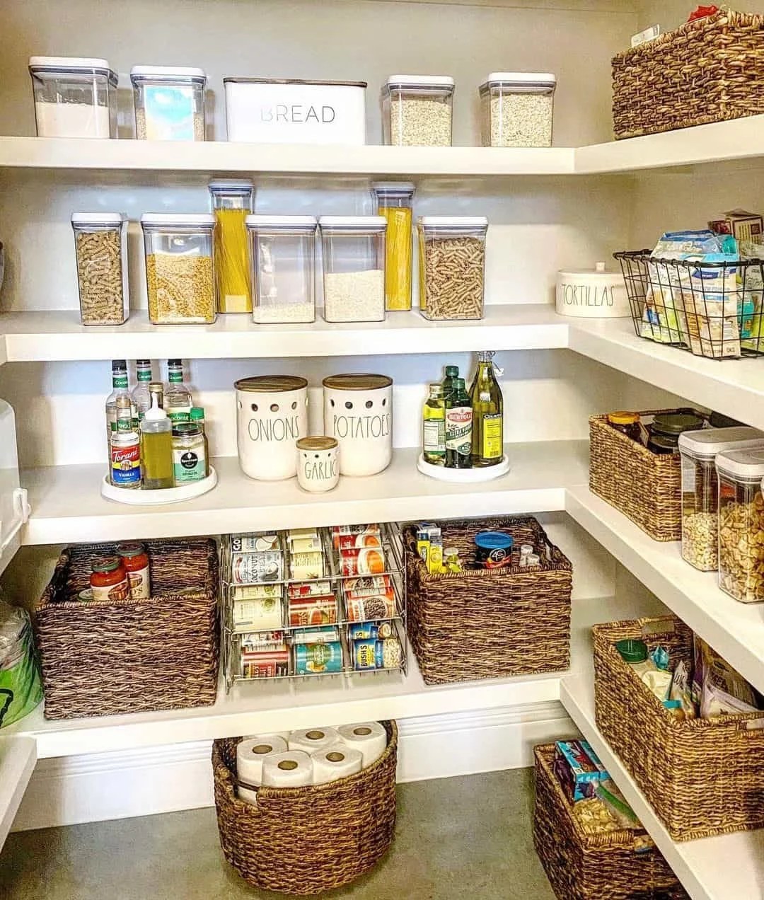Well-organized pantry using labeled bins for easy access.