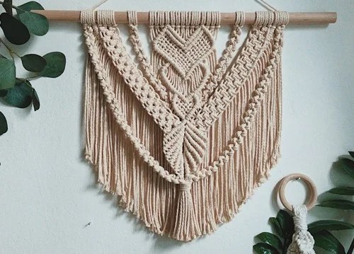 Whimsical feather macrame wall hanging for airy decor