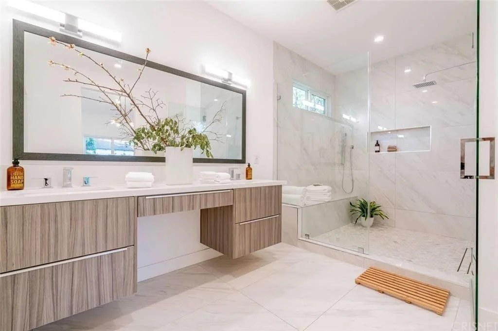 Glamorous bathroom featuring marble accents and mood lighting.