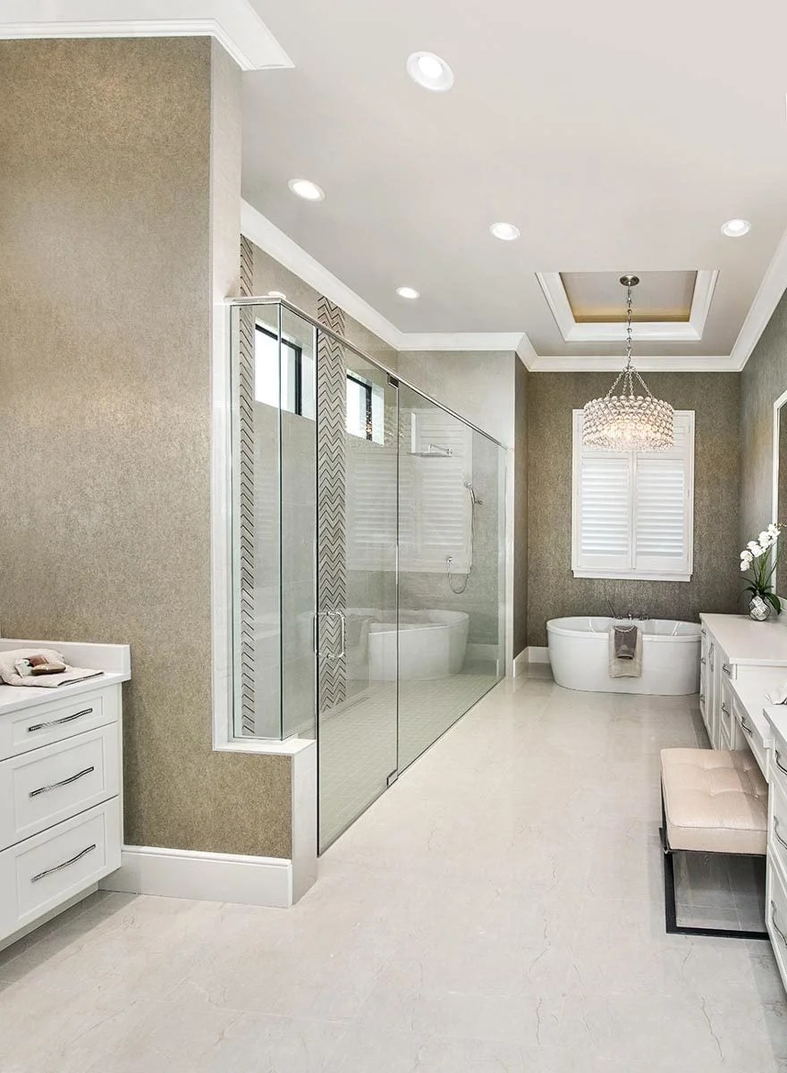Bright spa-like bathroom with natural light and decorative plants.