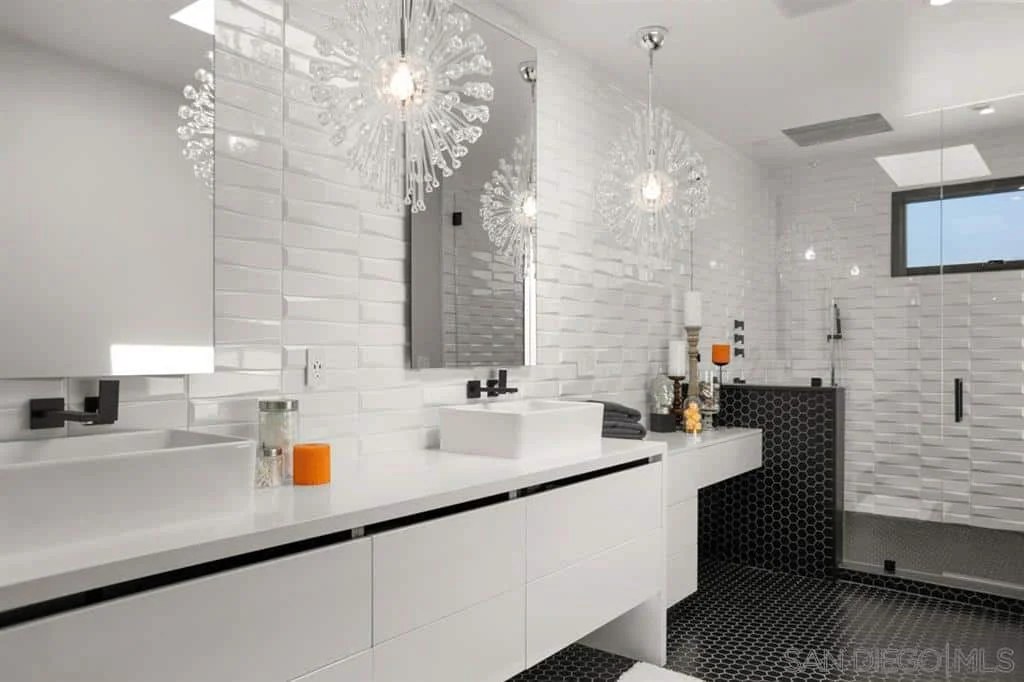 Bright white modern bathroom with double vanity and lovely lighting.