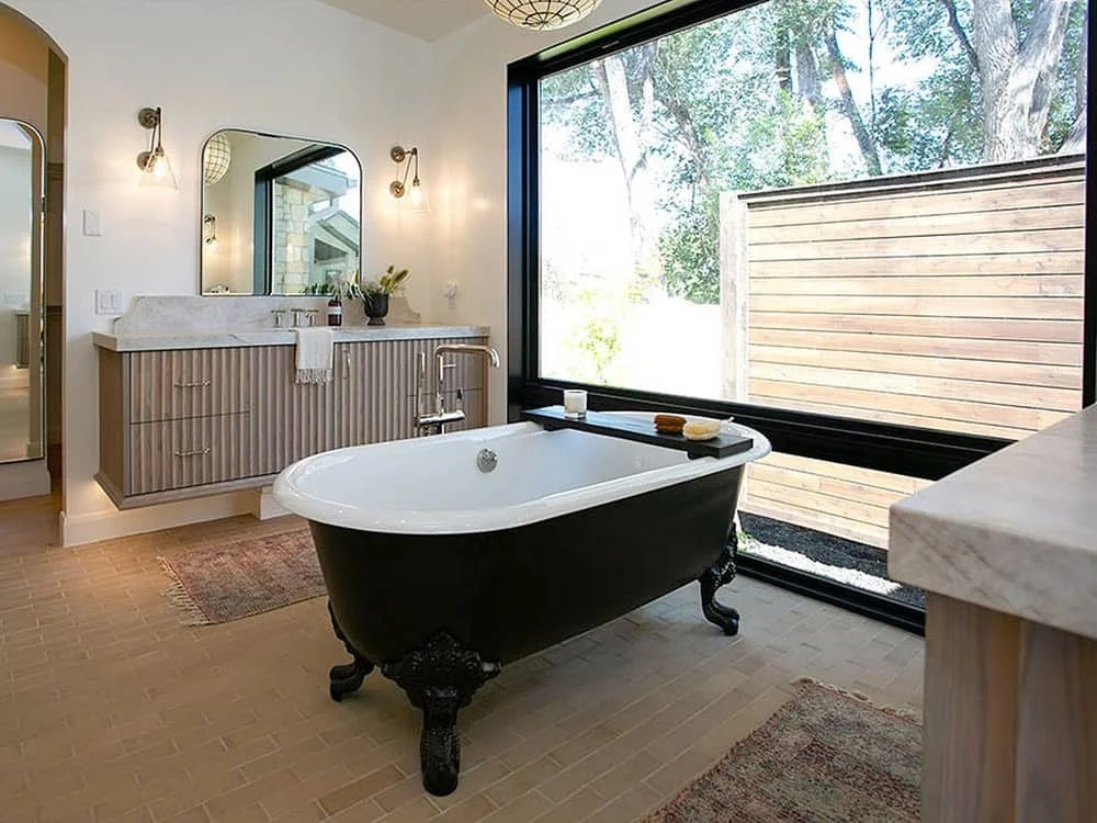 Rustic modern bathroom with vintage fixtures and natural stone.