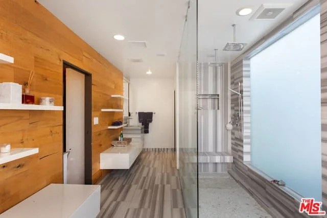 High-tech bathroom featuring smart shower and touchless faucets.