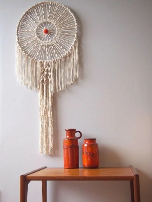 Circular woven dream catcher with tassels for a cozy vibe.