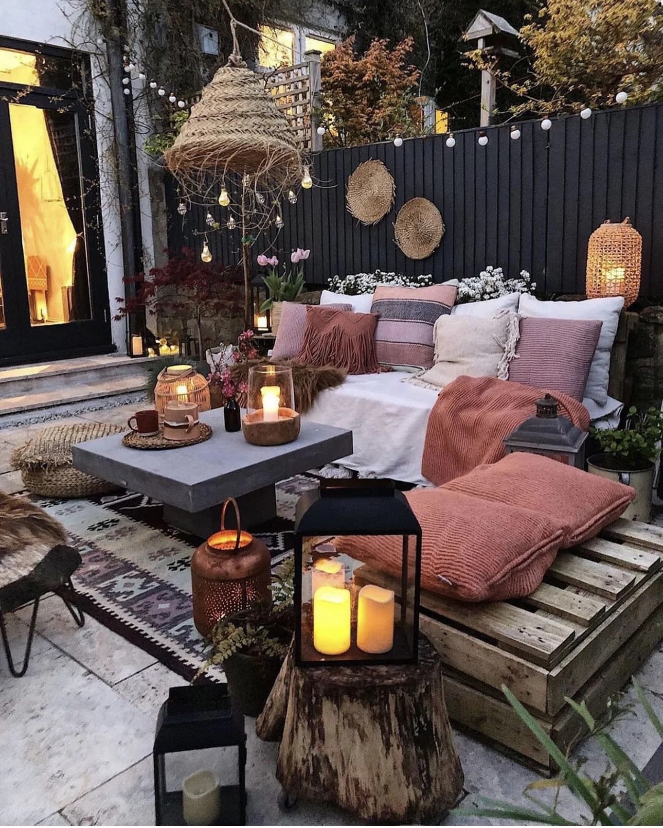 Upcycled pallet sofa with colorful cushions outdoors